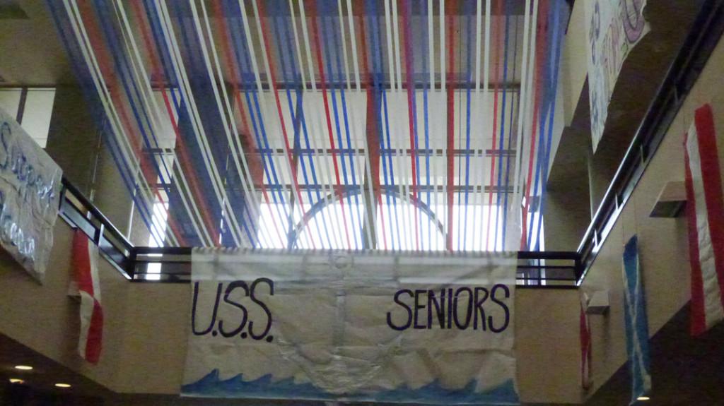 The large sign was painted on the spot by some talented cheerleaders , but hanging the streamers took nearly two hours.