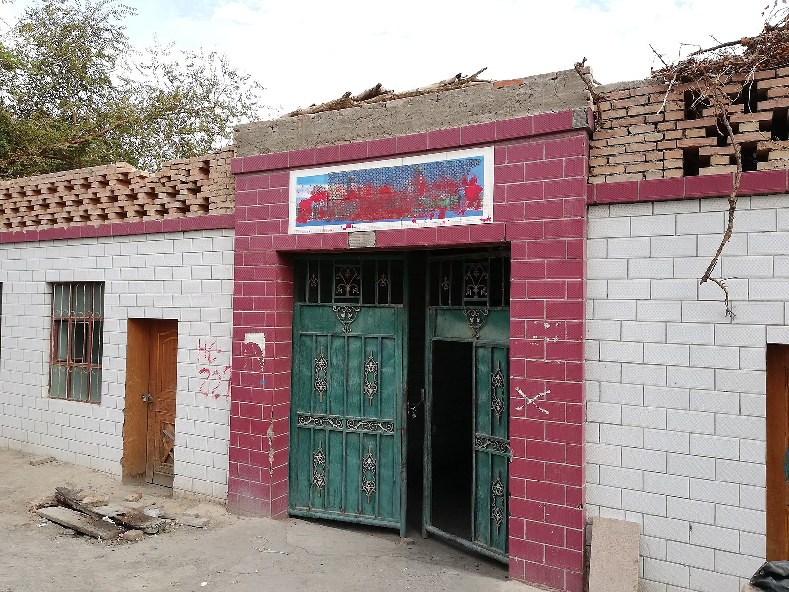 Household with painted-over images of mosques in Turban, a neighborhood in Eastern Xinjiang
